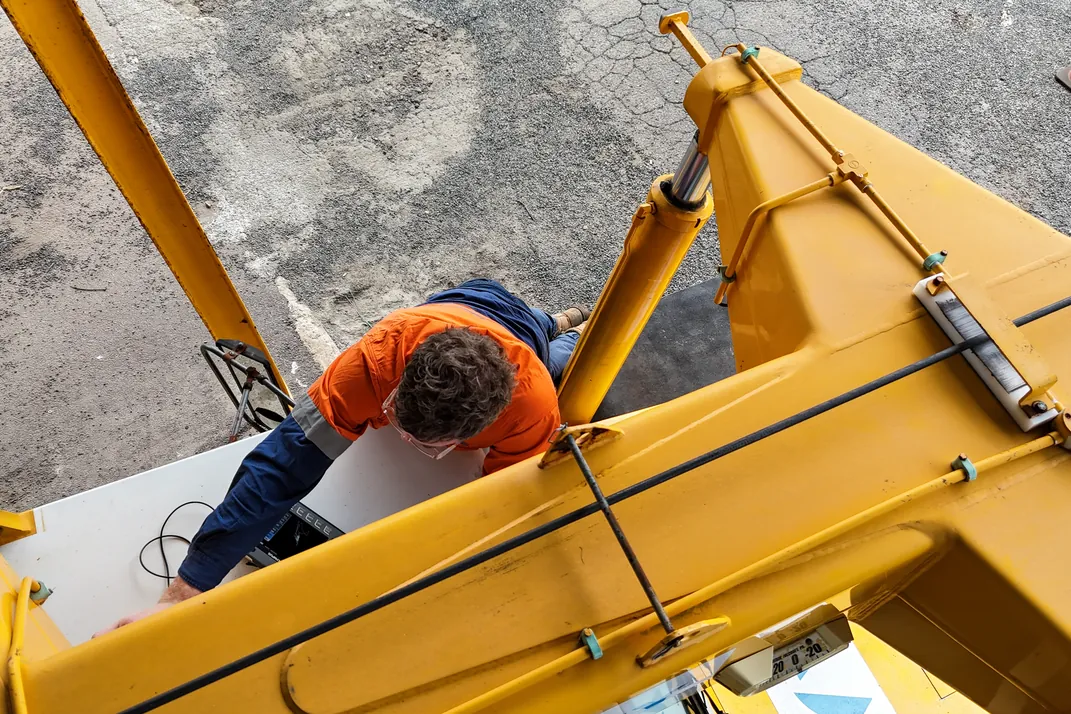 APEC Inspection technician inspecting the boom structure of a mobile crane