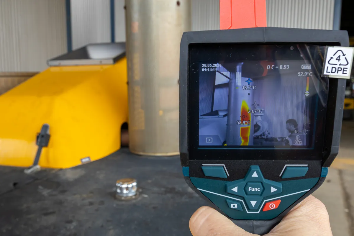 Thermal imaging camera display showing a temperature reading on equipment
