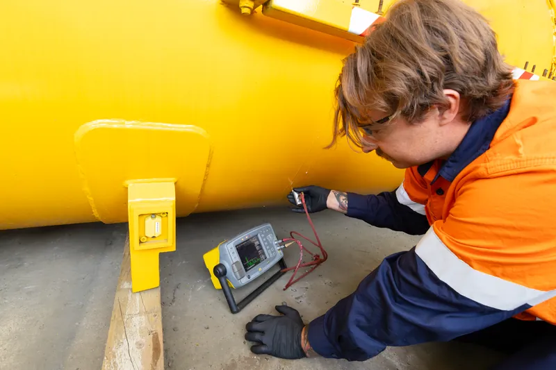 APEC technician taking ultrasonic thickness readings on a vessel shell