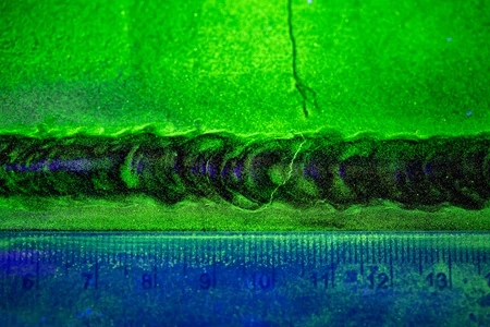 Fluorescent Magnetic Particle Test of a Crack in a Steel Butt Weld