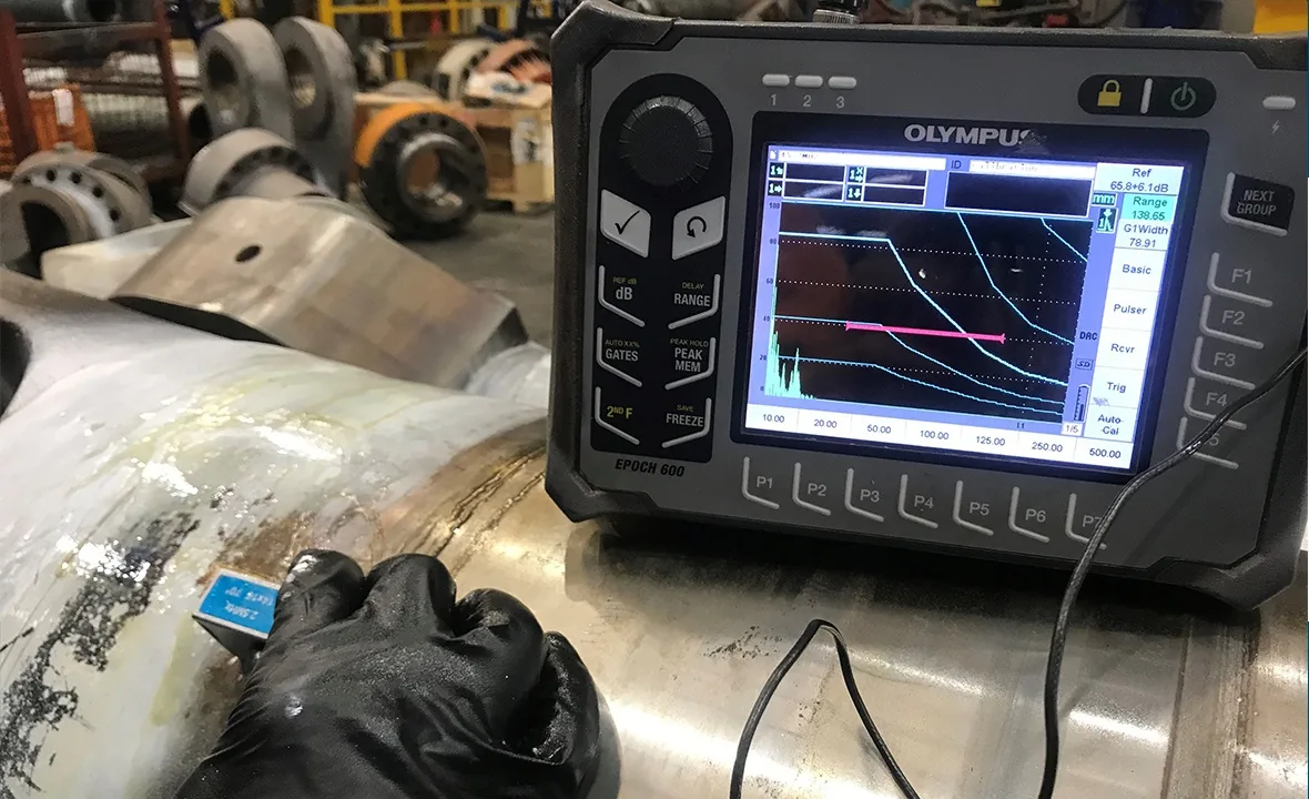Ultrasonic testing of a steel component by an APEC Inspection technician